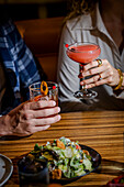 Two people toast each other in a stylish atmosphere