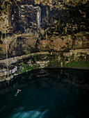 Aerial view of mystical cenote with one person swimming,Valladolid,Yucatan,Mexico