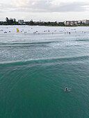 Aerial view of people enjoying the beach with a yellow lifeguard house by the gulf of Mexico,Siesta Key,United States