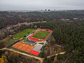 Aerial view of Vingio park featuring a beautiful forest,sports field,and stadium,Vilnius,Lithuania