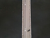 Aerial view of baltasis tiltas bridge over the serene neris river with three persons,vilnius,lithuania