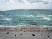 Aerial view of people enjoying a beautiful beach with lifeguard house and tranquil ocean,Miami Beach,United States