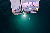 Aerial view of people watching Manta Rays at night from a boat along Alif Dhaal Atoll,Maldives