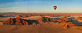Aerial view of hot air balloon flying over Namibia desert
