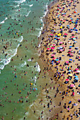 Aerial view of a crowded beach with colorful umbrellas and people enjoying the waves,Sariyer,Turkey