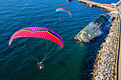 Aerial view of two paramotors flying over a shipwreck in Maltepe district on the Marmara Sea coast of the Asian side of Istanbul,Turkey