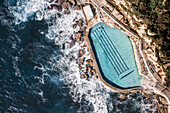 Aerial Top Down View Of Ocean Water Coastal Swimming Pool With Person Swimming In Bronte,Sydney,Australia