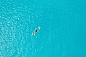 Aerial Top Down View Of Person Kayaking Over Clear Blue Ocean Water In Male,Maldives