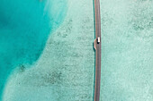 Aerial View Of a vehicle Crossing Bridge Over Clear Blue Ocean,South Male Atoll,Maldives