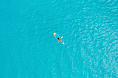 Aerial Top Down View Of Person Kayaking Over Clear Blue Ocean Water In Male,Maldives