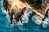 Aerial view of beautiful rugged cliffs and tranquil waves along the coastline,Athani,Greece