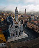 Aerial view of the historic Duomo di Siena amidst the beautiful old town and medieval architecture,Siena,Italy