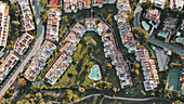 Aerial view of colourful houses beautifully arranged next to a wonderful golf course in Marbella,Spain