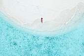 Aerial Top Down View Of Female Model Lying On White Sand Beach In South Male Atoll,Maldives