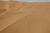 Aerial view of people doing a photo shooting on the sand dunes near Walvis Bay,Namibia