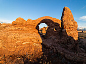 Aerial view of beautiful red rock formations and a natural arch at sunset,Moab,United States