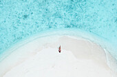 Aerial Top Down View Of Female Model Lying On White Sand Beach In South Male Atoll,Maldives