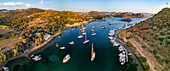 Aerial view of serene Gumusluk with anchored boats and sailboats,Aegean Sea,Bodrum,Turkey