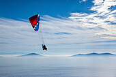 Aerial view of paramotor flying near Princes' Islands over foggy Marmara Sea in Asian side of Istanbul,Turkey