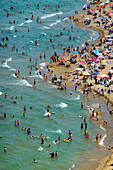 Aerial view of a crowded beach with sunbathers and colorful umbrellas by the Black Sea,Sariyer,Turkey