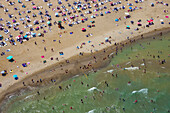 Aerial view of a crowded sandy beach with sunbathers and umbrellas by the Black Sea,Sariyer,Turkey