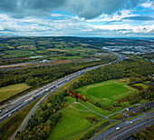 Aerial view of the iconic angel of the north surrounded by scenic countryside and vibrant greenery,Birtley,United Kingdom