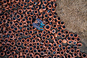 Sahajanpur,Bangladesh - 19 December 2021: Aerial view of a person working with clay pots in a factory,Bangladesh