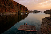 Aerial view of Lake Argyle at sunset with people rafting,Western Australia,Australia