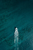 Aerial view of a boat driving in clear blue water,top down perspective,Western Australia