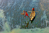 Badalgachhi,Bangladesh - 30 January 2021: Aerial view of fishermen on a canoe sailing the Jamuna river,Bangladesh