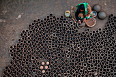 Sahajanpur,Bangladesh - 19 December 2021: Aerial view of a person working with clay pots in a factory,Bangladesh