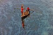 Badalgachhi,Bangladesh - 30 January 2021: Aerial view of fishermen on a canoe sailing the Jamuna river,Bangladesh