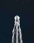 Aerial view of a motor boat that seems a rocket sailing the blue water,Sicily