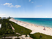 Aerial view of beautiful sandy beach with palm trees and ocean waves,Miami Beach,United States