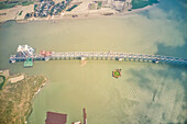 Aerial view of a building site while assembling the Padma bridge,the longest rail and highway bridge in Bangladesh crossing the Padma river,Zajira,Dhaka,Bangladesh
