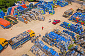 Rupganj ,Bangladesh - 06 September 2020: Aerial view of lorries loading oil barrels in a parking lot in Rupganj,Dhaka province,Bangladesh