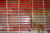 Aerial view of workers hanging coloured t-shirt fabrics to dry in Narayanganj,Dhaka,Bangladesh