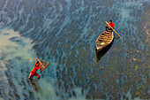 Badalgachhi,Bangladesh - 30 January 2021: Aerial view of fishermen on a canoe sailing the Jamuna river,Bangladesh