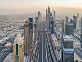 Aerial view of the traffic lanes and Skyscrapers in Dubai at sunset,U.A.E