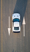 Aerial view of a car on road with arrow signs in Dubai,U.A.E