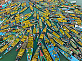 Bangladesh - 15 February 2023: Aerial view of floating market of seasonal fruits on the boats in Kaptai Lake,Rangamati,Bangladesh
