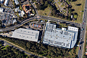 Aerial view of industrial warehouses and urban infrastructure with roads and greenery,Bonnyrigg,Australia
