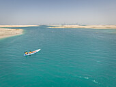 Aerial view of a couple kayaking in the middle of The world islands in Dubai,United Arab Emirates