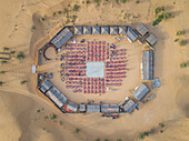 Aerial view of desert safari camp with straw roof huts,Al Awir,Dubai,UAE
