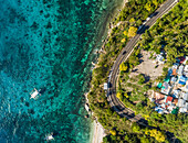 Aerial view of winding coastal road and boats in Oslob,Philippines