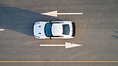 Aerial view of a car on road with arrow signs in Dubai,U.A.E