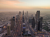 Aerial view of the traffic lanes and Skyscrapers in Dubai at sunset,U.A.E