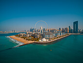Aerial view of Ain Dubai,world's largest Ferris wheel with Rotunda Caesar Palace in foreground and Dubai Marina skyline in background,United Arab Emirates