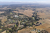 Aerial view of picturesque countryside with fields,homes,and a road in Bellbrae,Victoria,Australia