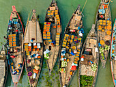 Aerial view of people trading with fruits and vegetables on boats along the river in Dhaka,Bangladesh